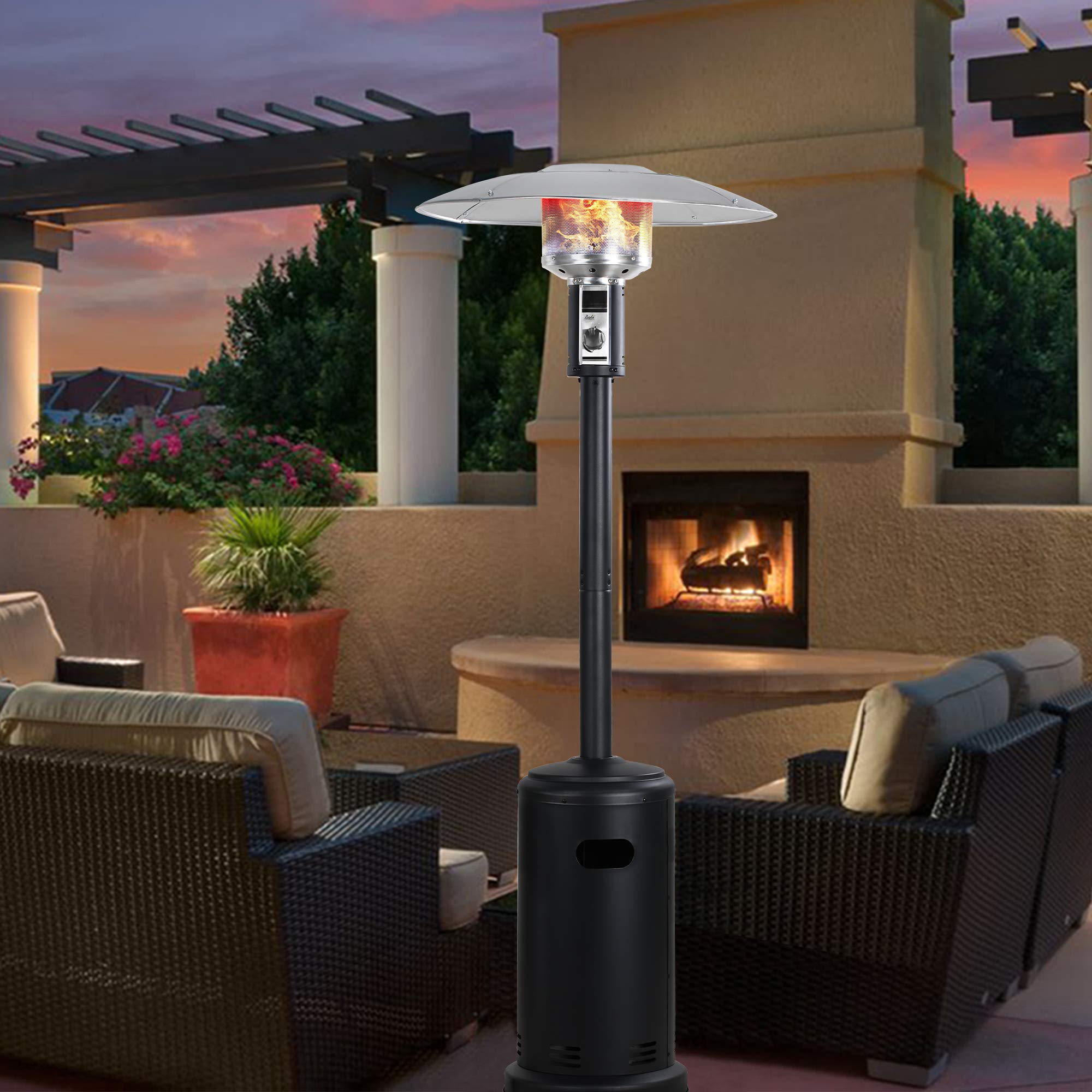 Black 32 inch propane patio heater with silver reflector and visible flames on a patio with seating.