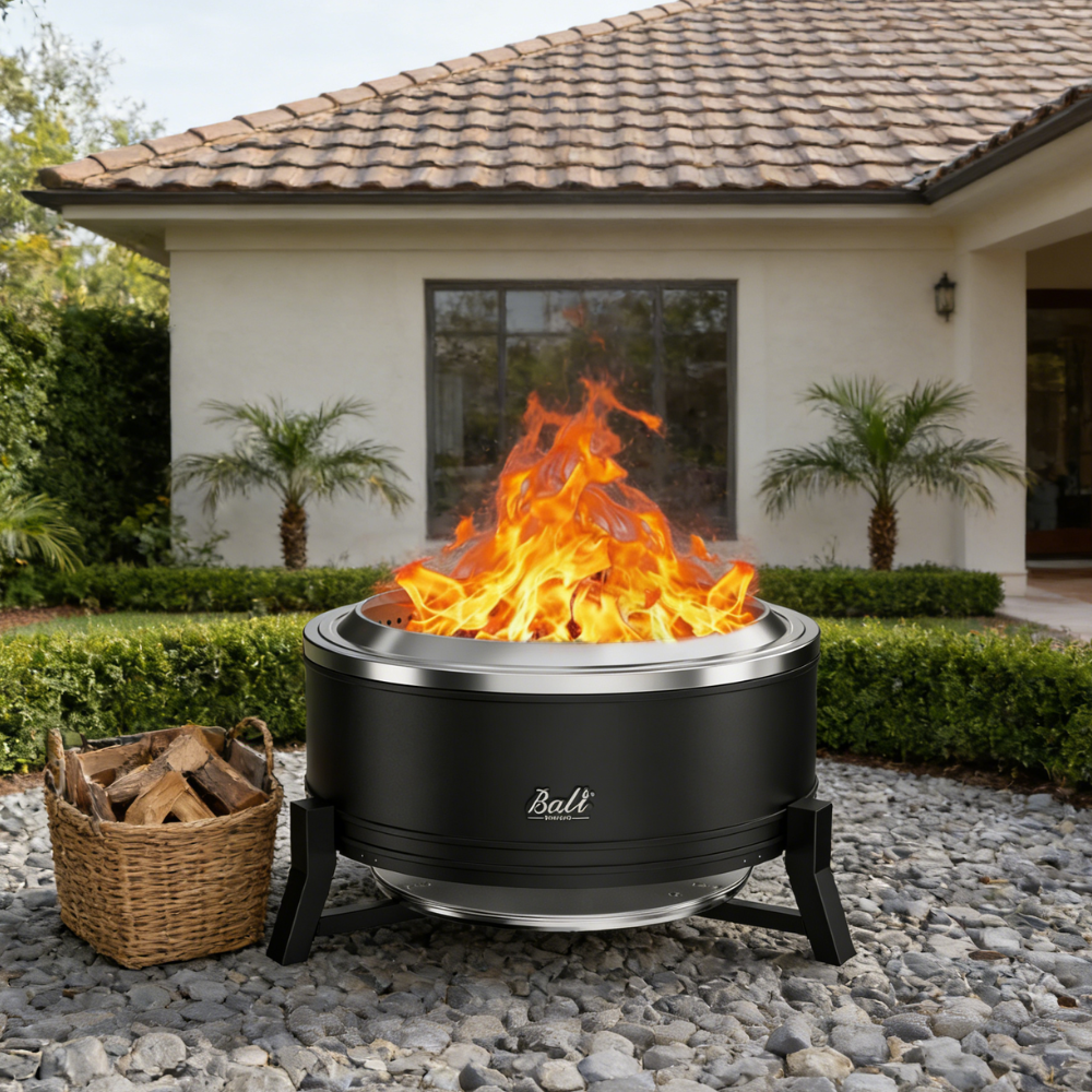 27-inch black Bali Outdoors smokeless fire pit with flames, ash pan, and basket of firewood.